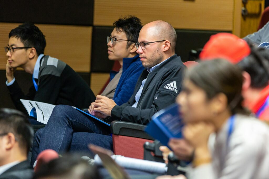 Lecture hall with 5 students listening to the professor.